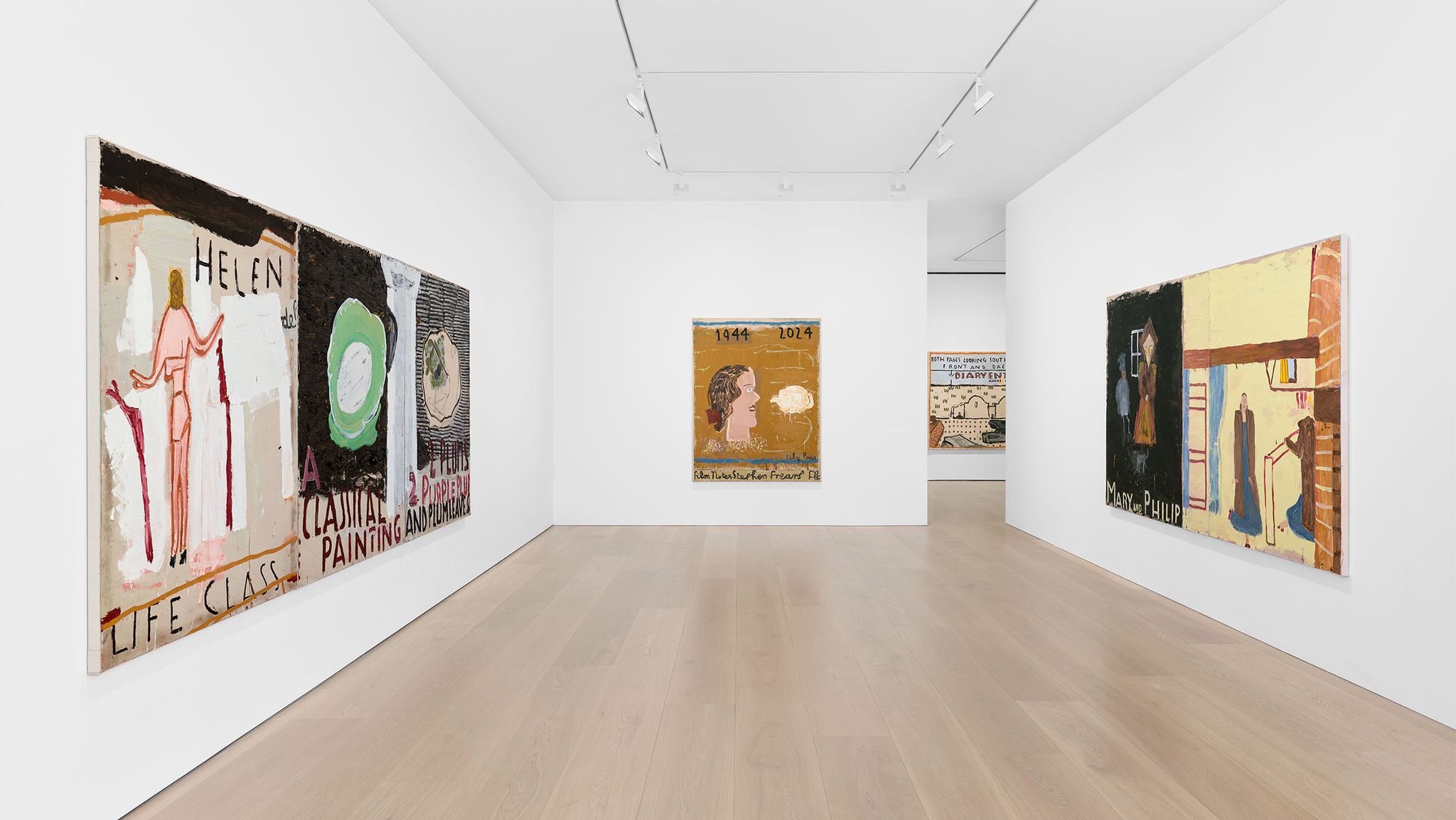 An art gallery featuring colorful paintings on white walls, with wooden floors and bright lighting enhancing the display.