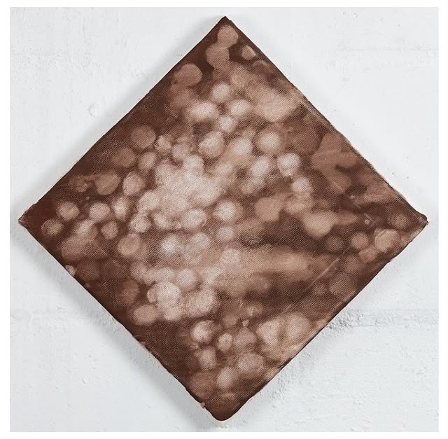 Square textile in earthy brown tones, featuring a cloudy, abstract pattern against a white backdrop.