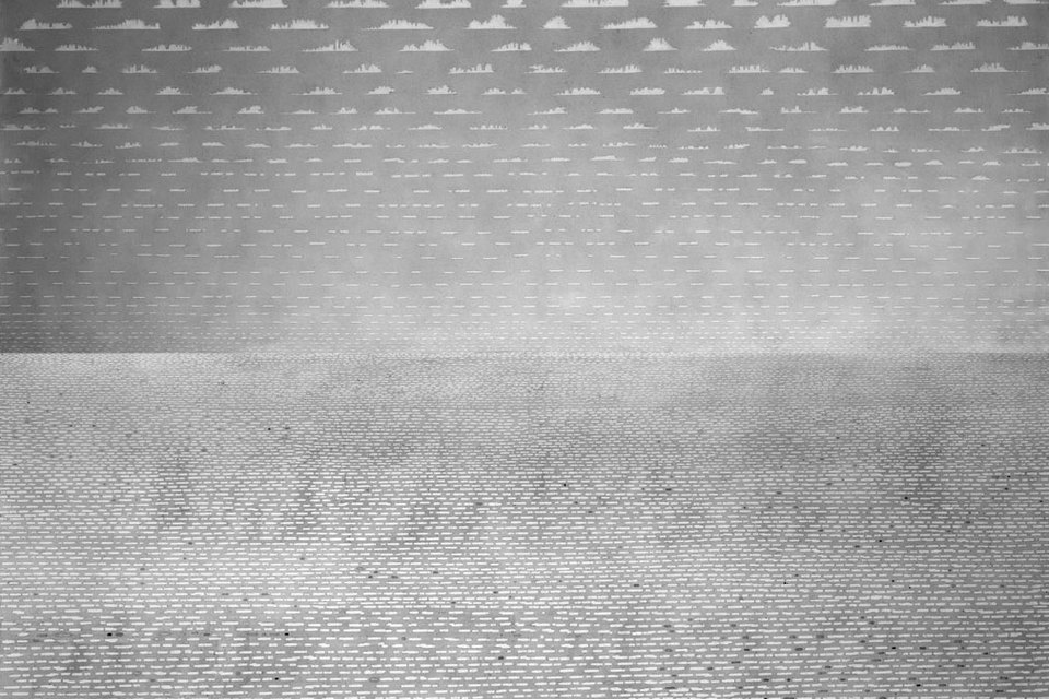 A textured monochrome landscape with a cloudy sky, featuring horizontal lines and subtle patterns across the sky and ground.