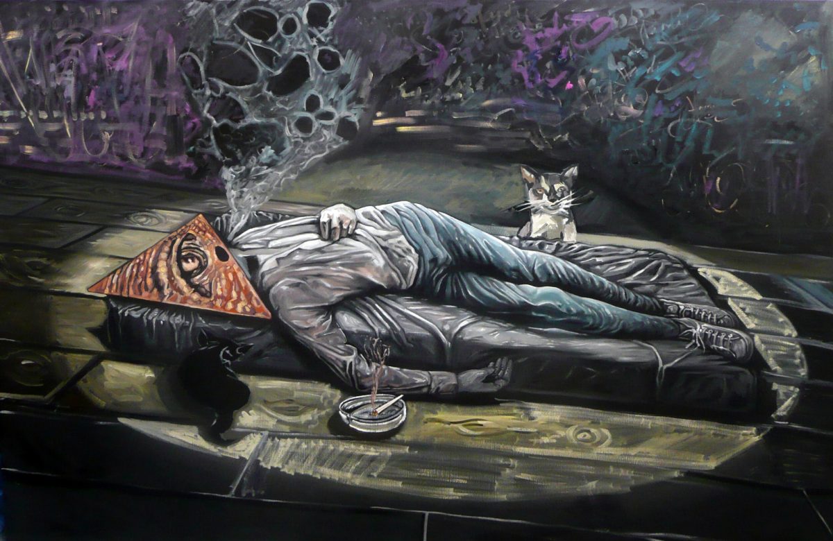 A person lies on a mattress with a pyramid-shaped mask, smoke rising, while a cat curiously watches in a dimly lit setting.