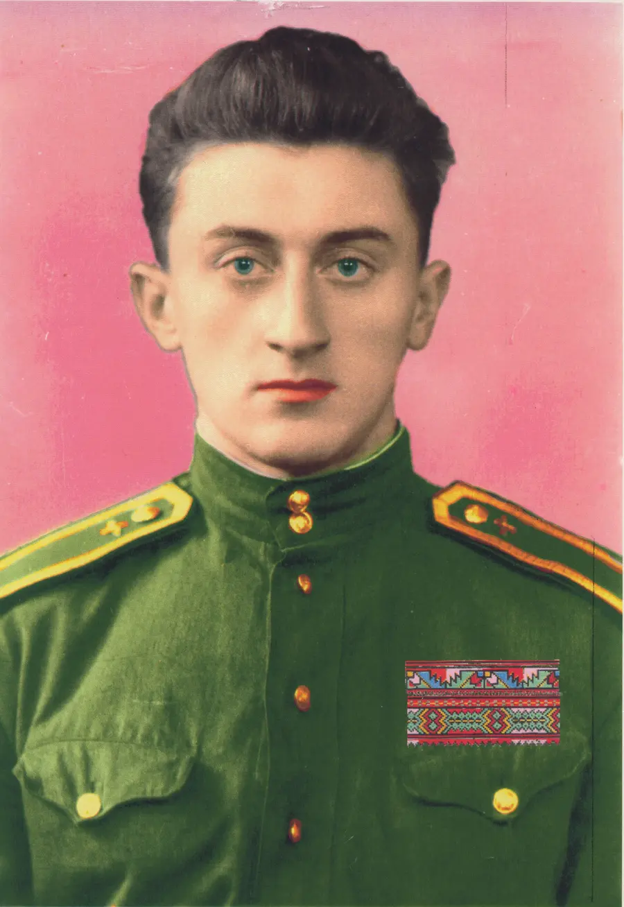 A man wearing a military uniform, showcasing his face and collar. The portrait highlights his chin and the green color of the uniform.