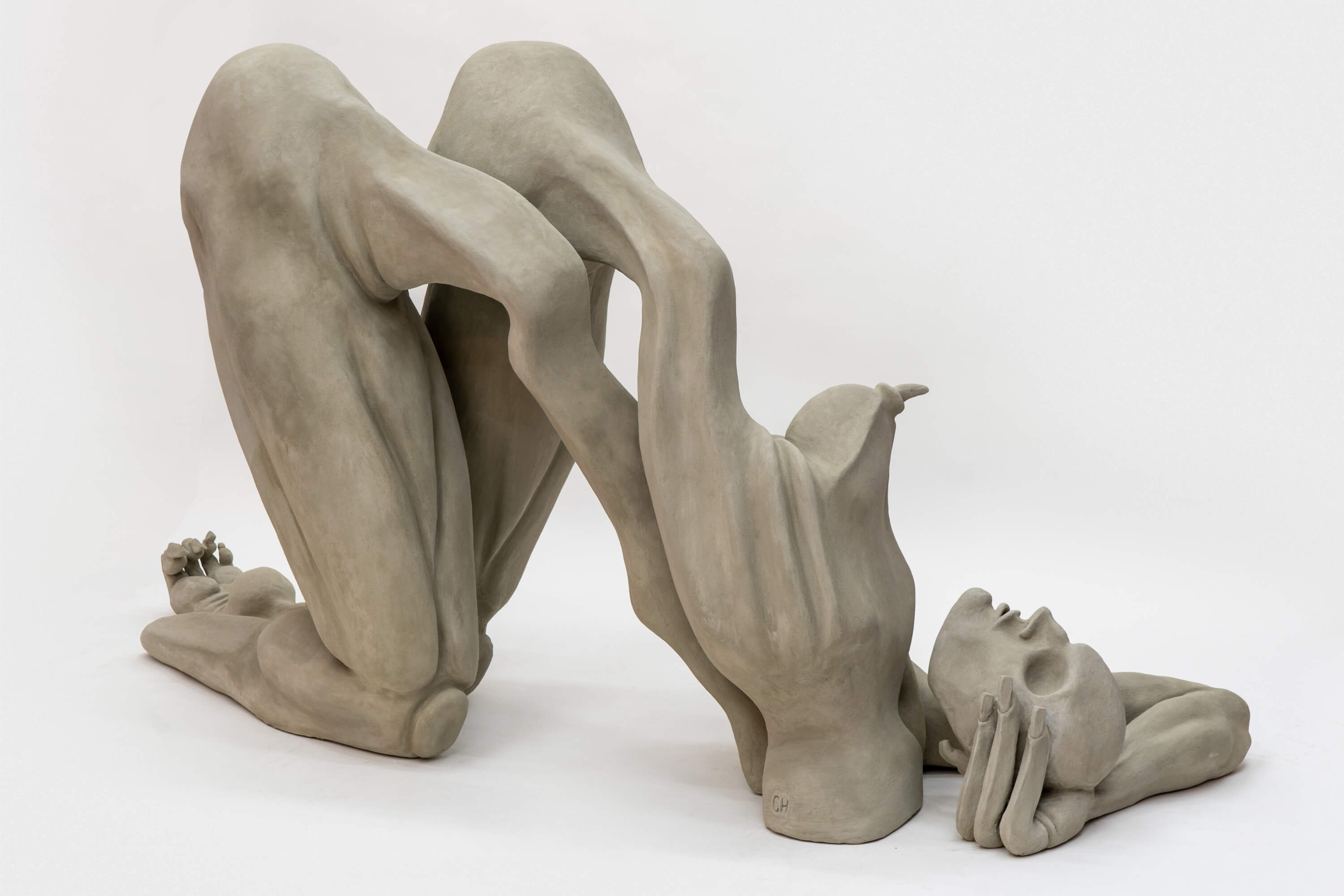 A unique sculpture depicting elongated human forms intertwined in a dynamic pose, evoking a sense of movement and emotion.