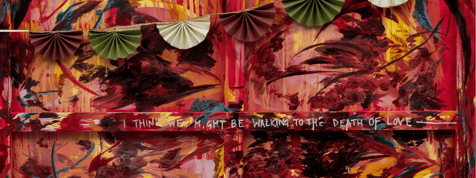 A vibrant abstract painting with swirling red, yellow, and black colors, featuring decorative paper fans and the text “I think I might be walking to the death of love.”